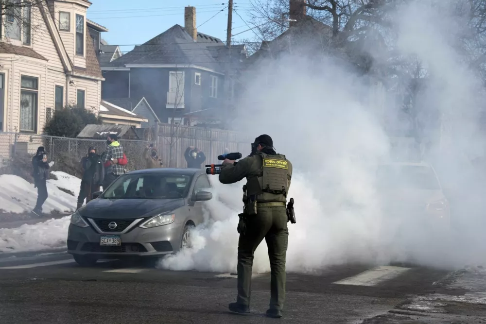 A federal agent holds a crowd-control weapon, following an incident where a civilian's car was hit by U.S. Immigration and Customs Enforcement (ICE) agents, after an ICE agent fatally shot Renee Nicole Good, in Minneapolis, Minnesota, U.S., January 12, 2026.  REUTERS/Tim Evans