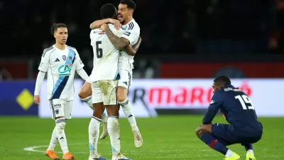Soccer Football - Coupe de France - Round of 32 - Paris St Germain v Paris FC - Parc des Princes, Paris, France - January 12, 2026 Paris FC's Otavio and Timothee Kolodziejczak celebrate after the match as Paris St Germain's Ousmane Dembele looks dejected REUTERS/Gonzalo Fuentes   TPX IMAGES OF THE DAY