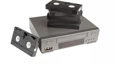 stack of videotapes on videorecorder isolated on white background