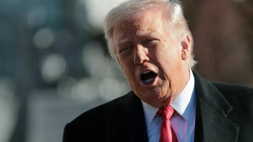 U.S. President Donald Trump speaks to reporters, on his way to the Marine One helicopter to depart the White House for travel to Detroit, Michigan, in Washington, D.C. U.S. January 13, 2026. REUTERS/Jonathan Ernst