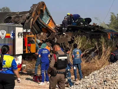 This photo released from State Railway of Thailand, shows aid workers after a construction crane fell into a passenger train in Nakhon Ratchasima province, Thailand Wednesday, Jan. 14, 2026. (State Railway of Thailand via AP)