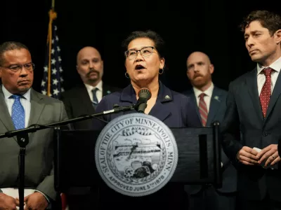 Saint Paul Mayor Kaohly Her speaks at a press conference, while Minneapolis Mayor Jacob Frey and Minnesota Attorney General Keith Ellison listen, after an ICE agent fatally shot Renee Nicole Good, in Minneapolis, Minnesota, U.S., January 12, 2026.  REUTERS/Tim Evans