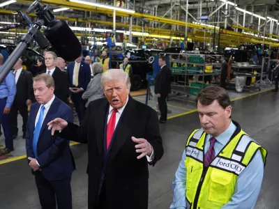 President Donald Trump speaks as Bill Ford, Executive Chairman of Ford, left, and Jim Farley, CEO of Ford, listen during a tour of the Ford River Rogue complex, Tuesday, Jan. 13, 2026, in Dearborn, Mich. (AP Photo/Evan Vucci)