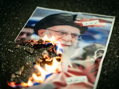 A buring image of the Ayatollah Ali Khamenei is seen during rally in support of the nationwide mass demonstrations in Iran against the government, Tuesday, Jan. 13, 2026 in Zuerich, Switzerland.(Michael Buholzer /Keystone via AP)