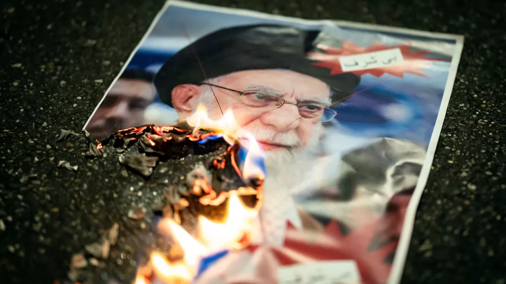 A buring image of the Ayatollah Ali Khamenei is seen during rally in support of the nationwide mass demonstrations in Iran against the government, Tuesday, Jan. 13, 2026 in Zuerich, Switzerland.(Michael Buholzer /Keystone via AP)