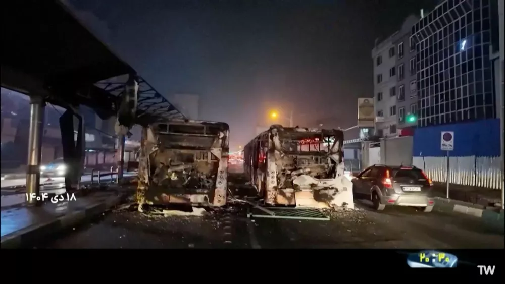 Burnt vehicles lie on the road following unrest sparked by dire economic conditions, in a place given as Tehran, Iran, January 10, 2026, in this screengrab from Iran's state media broadcast footage. IRIB via WANA(West Asia News Agency) via REUTERS ATTENTION EDITORS - THIS PICTURE WAS PROVIDED BY A THIRD PARTY. IRAN OUT. NO COMMERCIAL OR EDITORIAL SALES IN IRAN NO USE BBC PERSIAN. NO USE VOA PERSIAN. NO USE MANOTO. NO USE IRAN INTERNATIONAL. NO USE RADIO FARDA. FOR REUTERS CUSTOMERS ONLY. TEXT OVERLAY FROM SOURCE.
