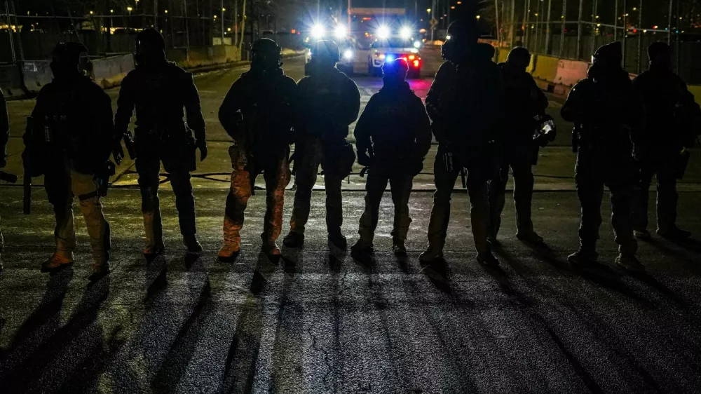 Members of law enforcement stand guard outside the Whipple Federal Building, days after an ICE agent fatally shot Renee Nicole Good, in Minneapolis, Minnesota, U.S., January 13, 2026. REUTERS/Ryan Murphy / Foto: Ryan Murphy