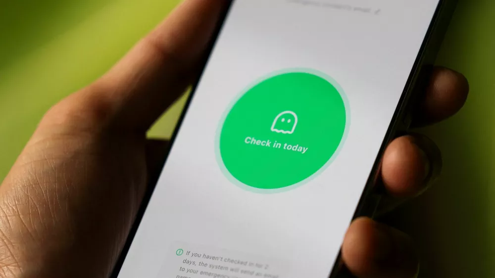 "Are you dead" app, or "Demumu" in its english version, a Chinese safety tool designed for people living alone, on a mobile phone in this illustration picture taken January 14, 2026. REUTERS/Tingshu Wang/Illustration