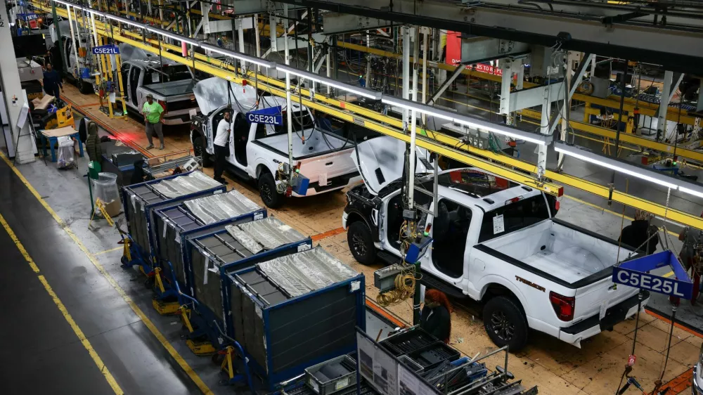 Employees work at the Ford production center, on the day of a visit by U.S. President Donald Trump, in Dearborn, Michigan, U.S., January 13, 2026. REUTERS/Evelyn Hockstein