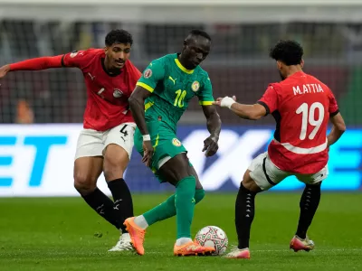 Senegal's Sadio Mane, center, is challenged by Egypt's Hossam Abdelmaguid, left, and Egypt's Marwan Attia during the Africa Cup of Nations semifinal soccer match between Senegal and Egypt, in Tangier, Morocco, Wednesday, Jan. 14, 2026. (AP Photo/Themba Hadebe)