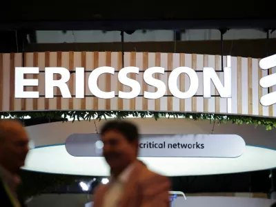 FILE PHOTO: Attendees talk near the Ericsson exhibitor stall at the ongoing India Mobile Congress 2025 at Yashobhoomi, a convention and expo center in New Delhi, India, October 8, 2025. REUTERS/Anushree Fadnavis/File Photo