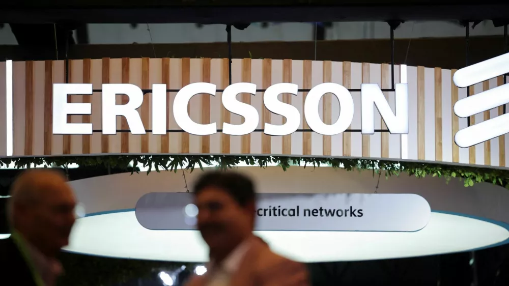 FILE PHOTO: Attendees talk near the Ericsson exhibitor stall at the ongoing India Mobile Congress 2025 at Yashobhoomi, a convention and expo center in New Delhi, India, October 8, 2025. REUTERS/Anushree Fadnavis/File Photo