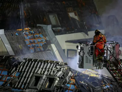 A firefighter works at the site of a large fire that broke out following an explosion, in Utrecht, Netherlands, January 15, 2026. REUTERS/Piroschka Van De Wouw