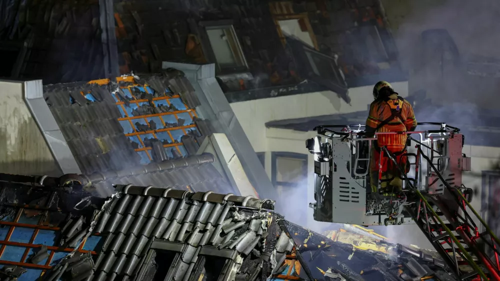 A firefighter works at the site of a large fire that broke out following an explosion, in Utrecht, Netherlands, January 15, 2026. REUTERS/Piroschka Van De Wouw
