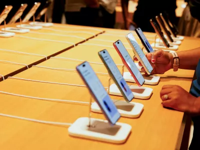 FILE PHOTO: A person holds an Apple iPhone at the company's first retail store in Bengaluru, India, September 2, 2025. REUTERS/Priyanshu Singh/File Photo