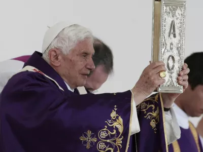 Pope Benedict XVI holds up the book of the gospel as he celebrates Mass in Bicentennial Park near Silao, Mexico, Sunday March 25, 2012. (AP Photo/Gregorio Borgia)