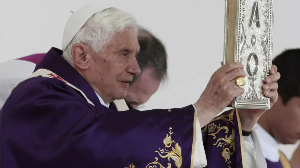 Pope Benedict XVI holds up the book of the gospel as he celebrates Mass in Bicentennial Park near Silao, Mexico, Sunday March 25, 2012. (AP Photo/Gregorio Borgia)