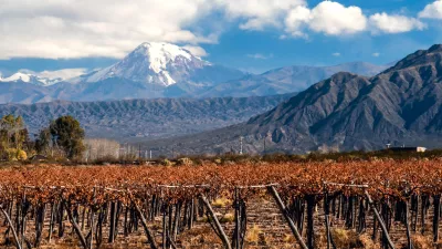 Volcano Aconcagua and Vineyard. Aconcagua is the highest mountain in the Americas at 6,962 m (22,841 ft). It is located in the Andes mountain range, in the Argentine province of Mendoza