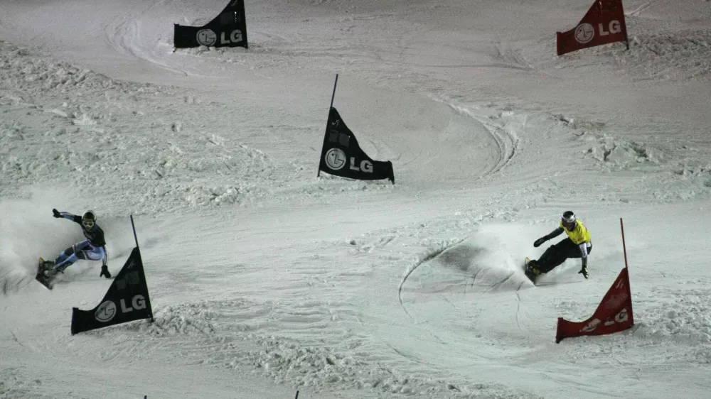 Winner Aaron March of Italy, left, competes with the second placed Benjamin Karl of Austria during a men's parallel slalom Snowboard FIS World Cup in Moscow, Russia, Saturday, March 6, 2010. (AP Photo/Mikhail Metzel)