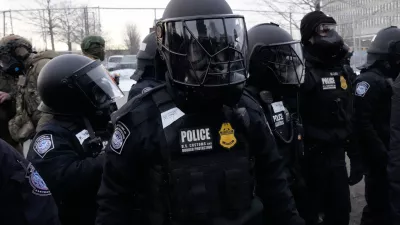 U.S. Customs and Border Protection police officers stand outside the Bishop Henry Whipple Federal Building during a protest on Saturday, Jan. 17, 2026, in Minneapolis. (AP Photo/Yuki Iwamura)
