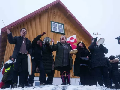 Inuits sing a national song during a protest against Trump's policy towards Greenland in front of the US consulate in Nuuk, Greenland, Saturday, Jan. 17, 2026. (AP Photo/Evgeniy Maloletka)