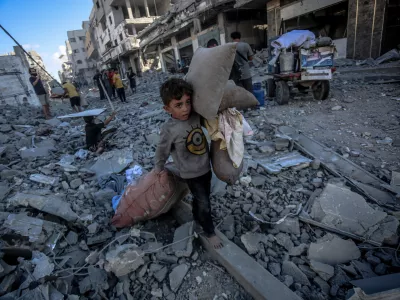GAZA CITY, GAZA - SEPTEMBER 30: Palestinian children collect usable belongings from the rubble after the Israeli strike on Abu Hasira Street in Gaza City, Gaza, on September 30, 2025. Several buildings were completely destroyed, and many others were severely damaged in the strike. Saeed M. M. T. Jaras / AnadoluNo Use USA No use UK No use Canada No use France No use Japan No use Italy No use Australia No use Spain No use Belgium No use Korea No use South Africa No use Hong Kong No use New Zealand No use Turkey
