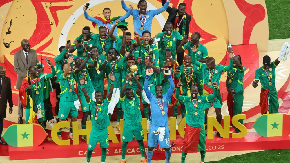 Senegal's Sadio Mane holds the trophy aloft as he celebrates with teammates after winning the Africa Cup of Nations final soccer match between Senegal and Morocco in Rabat, Morocco, Sunday, Jan. 18, 2026. (AP Photo/Youssef Loulidi)