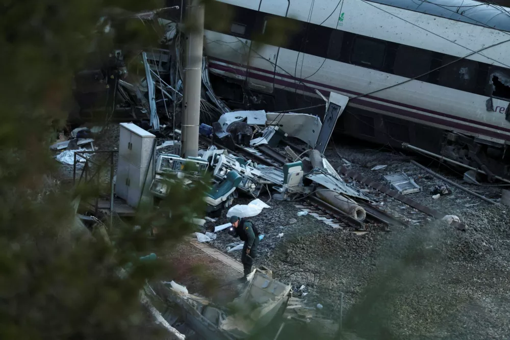 A member of the Spanish Civil Guard searches underneath the wreckage of a train&nbsp;involved in the accident, at the site of a deadly derailment of two high-speed trains near Adamuz, in Cordoba, Spain, January 20, 2026. REUTERS/Susana Vera   TPX IMAGES OF THE DAY