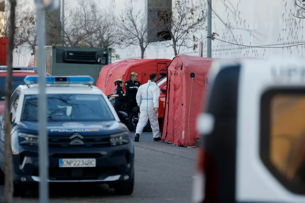 A member of the Emergency Military Unit in PPE (Personal Protective Equipment) walks outside the City of Justice building, which is being used as a morgue, following the deadly derailment of two high-speed trains near Adamuz, in Cordoba, Spain, January 20, 2026. REUTERS/Jon Nazca