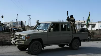 Syrian Democratic Forces (SDF) fighters ride in a pick-up truck, following clashes between SDF and Syrian government forces, in Hasakah, Syria, January 20, 2026. REUTERS/Orhan Qereman