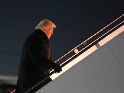 President Donald Trump boards Air Force One for a trip to attend the World Economic Form in Davos, Tuesday, Jan. 20, 2026, at Joint Base Andrews, Md. (AP Photo/Evan Vucci)