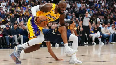 Los Angeles Lakers forward LeBron James (23) fouls Denver Nuggets guard Jamal Murray (27) during the first half of an NBA basketball game Tuesday, Jan. 20, 2026, in Denver. (AP Photo/Jack Dempsey)
