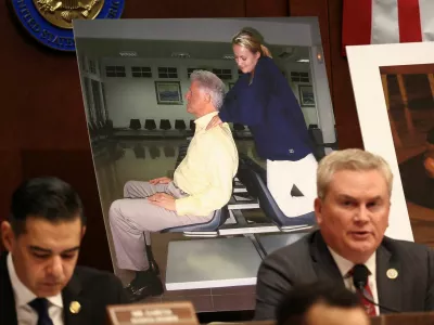Images of former U.S. President Bill Clinton are on display as Chairman of the House Oversight Committee James Comer (R-KY) speaks during a meeting to vote on whether to hold Clinton and former Secretary of State Hillary Clinton in contempt of Congress for defying subpoenas to testify in the panel's investigation of the late convicted sex offender Jeffrey Epstein, on Capitol Hill in Washington, D.C., U.S., January 21, 2026. REUTERS/Kevin Lamarque
