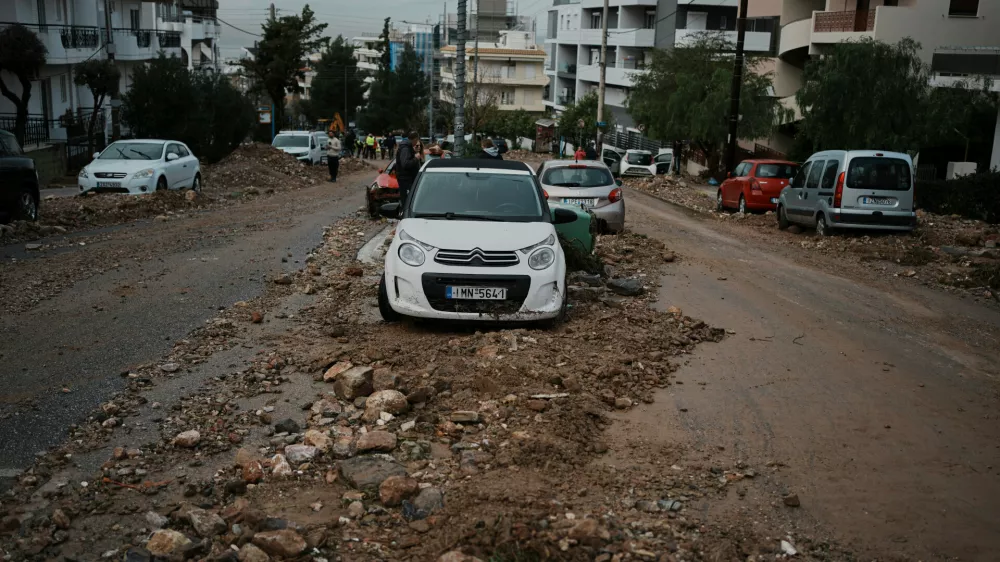Mud and stones cover a street after flooding caused by heavy rain in the Glyfada district of Athens, Thursday, Jan. 22, 2026. (AP Photo/Thanassis Stavrakis)