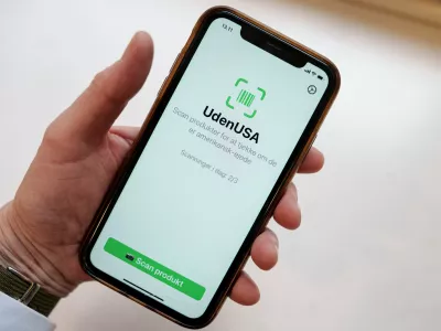 Close up on a cell phone with the app called "UdenUSA", which translates to withoutUSA in Danish and can filter out American products in supermarkets, in Copenhagen, Wednesday Jan. 21, 2026. (Liselotte Sabroe/Ritzau Scanpix via AP)