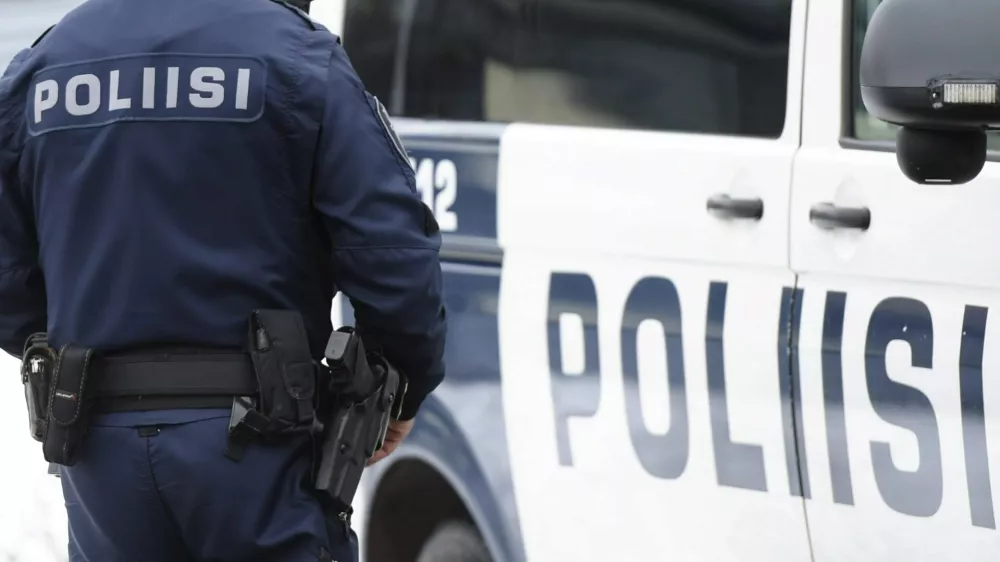 10 March 2016, Finland, Helsinki: A police officer stands next to a vehicle during the Police Local Defense West 1 exercise in Laajasalo. Photo: Vesa Moilanen/Lehtikuva/dpa