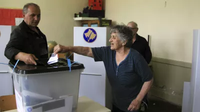 A Kosovo Serb casts her ballot at a polling centre in the village of Gracanica, close to capital Pristina June 8, 2014. Kosovo voted in an election on Sunday marked by voter frustration over poverty and corruption six years after seceding from Serbia, testing ex-guerrilla Hashim Thaci's bid for a third term as prime minister. REUTERS/Hazir Reka (KOSOVO - Tags: POLITICS ELECTIONS)