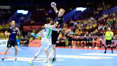 Slovenia's Domen Makuc tries to stop Sweden's Eric Johansson, top, during the European Championship handball match between Slovenia and Sweden, in Malmo, Sweden, Friday Jan. 23, 2026. (Andreas Hillergren/TT via AP)