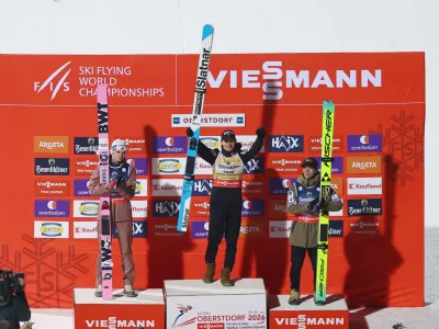 Ski Jumping - Ski Flying World Championships - Heini-Klopfer Ski Flying Hill, Oberstdorf, Germany - January 24, 2026 Slovenia's Domen Prevc celebrates on the podium after winning the men's individual HS235 with second placed Norway's Marius Lindvik and third placed Japan's Ren Nikaido REUTERS/Kai Pfaffenbach