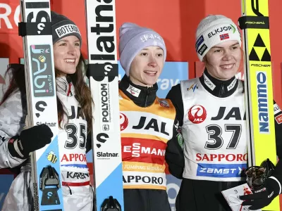 Winner Nika Prevc of Slovenia, center, second place Abigail Strate of Canada, left, and third place Anna Odine Strom of Norway celebrate after the women's large hill individual event, during the Ski Jumping World Cup in Sapporo, northern Japan, Saturday Jan. 24, 2026. (Yuta Omori/Kyodo News via AP)