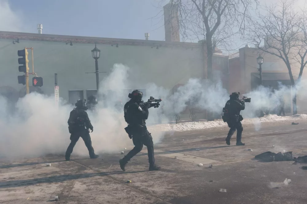 Minneapolis Police fire munitions at demonstrators near the site where a man identified as Alex Pretti was fatally shot by federal agents trying to detain him, in Minneapolis, Minnesota, U.S., January 24, 2026. REUTERS/Tim Evans