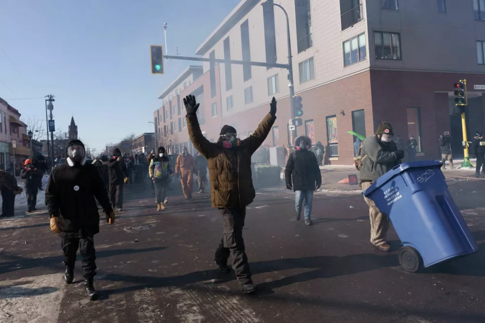 Demonstrators chant and walk towards law enforcement as they depart the site where a man identified as Alex Pretti was fatally shot by federal agents trying to detain him, in Minneapolis, Minnesota, U.S., January 24, 2026.REUTERS/Tim Evans
