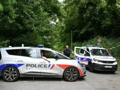 Police France, francija, policija, french police, francoska policijaPolice cars are parked in front of a cordoned-off area, near a sports field where a 32-year-old man was found dead with his throat slit and gutted, in Pont-de-Metz on August 4, 2025. The victim had stab wounds to the neck and back and has been found by a walker in a cross position, police told AFP.,Image: 1027676326, License: Rights-managed, Restrictions:, Model Release: no