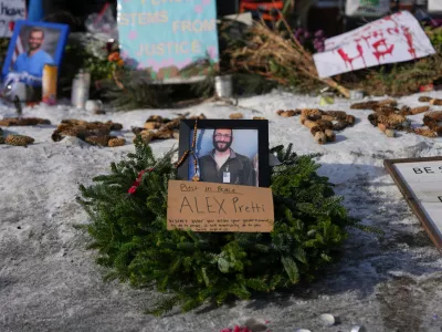 A makeshift memorial is placed where Alex Pretti was fatally shot by a U.S. Border Patrol officer yesterday, in Minneapolis, Sunday, Jan. 25, 2026. (AP Photo/Adam Gray)