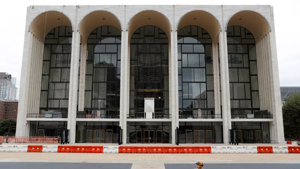 A child plays in front of the Metropolitan Opera House, which announced it will cancel its entire 2020-21 season due to the outbreak of the coronavirus disease (COVID-19) in Manhattan, New York City, U.S., September 26, 2020. REUTERS/Andrew Kelly