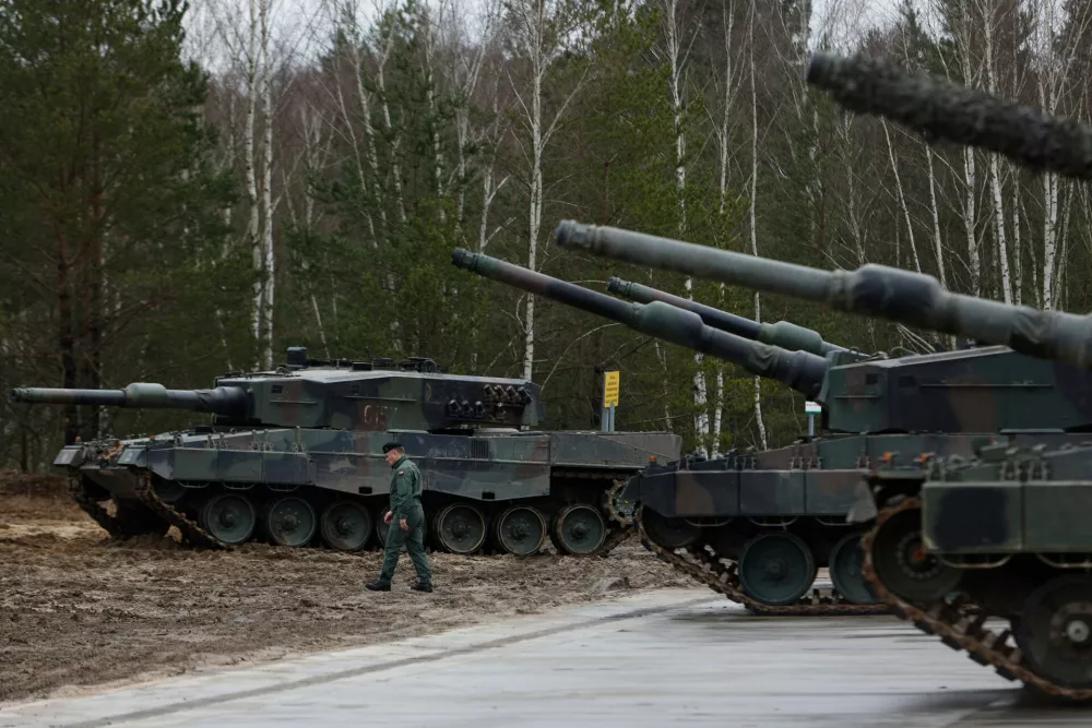 FILE - A Polish soldier walks next to the Leopard 2 tanks during a training at a military base and test range in Swietoszow, Poland, Monday, Feb. 13, 2023. (AP Photo/Michal Dyjuk, File)