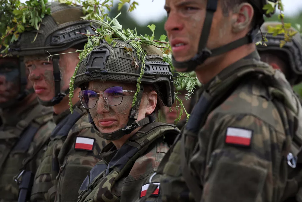 Thirty six-year-old administrator Agnieszka Jedruszak stands with other recruits during voluntary military training at the training ground in Braniewo, Poland, June 24, 2025. REUTERS/Kacper Pempel