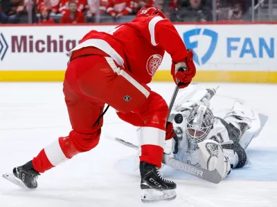 Los Angeles Kings goaltender Anton Forsberg deflects a shot on goal against Detroit Red Wings center Emmitt Finnie during the first period of an NHL hockey game, Tuesday, Jan. 27, 2026, in Detroit. (AP Photo/Duane Burleson)