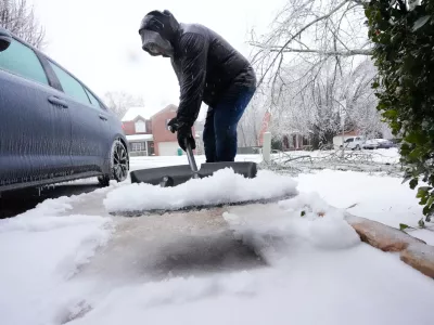 Ice and snow are shoveled during a winter storm Sunday, Jan. 25, 2026, in Nashville, Tenn. (AP Photo/George Walker IV, File)