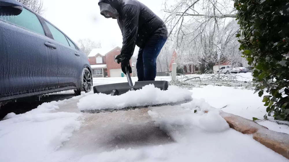 Ice and snow are shoveled during a winter storm Sunday, Jan. 25, 2026, in Nashville, Tenn. (AP Photo/George Walker IV, File)